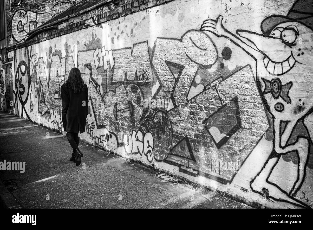 Woman & Graffiti, Near Brick Lane, London Stock Photo