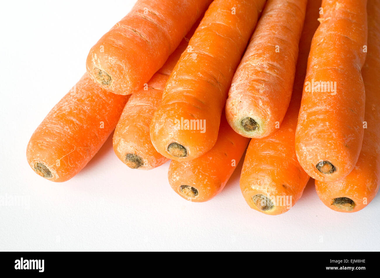 Pile of unpeeled orange carrots. Stock Photo
