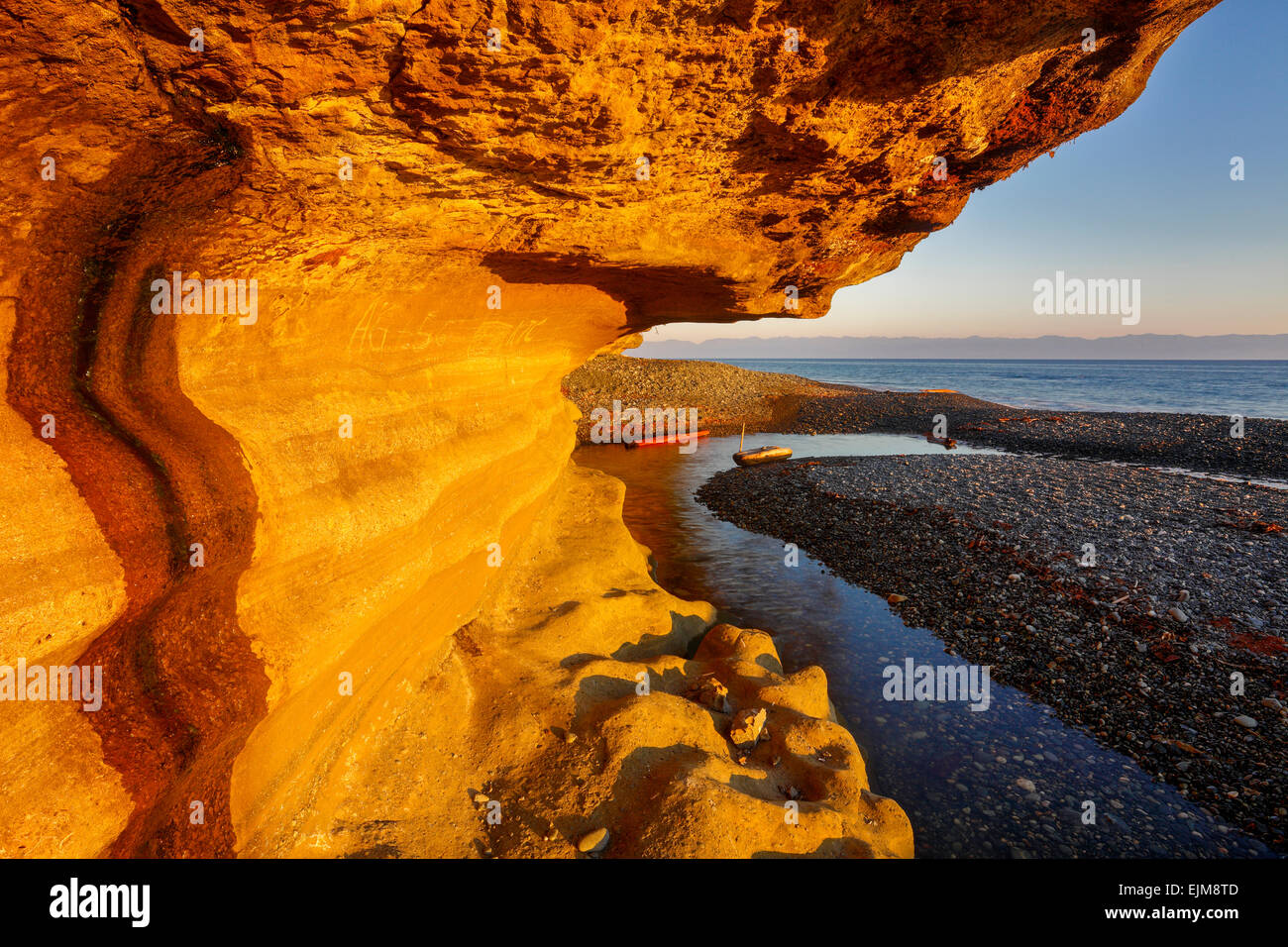 Sandstone cliff face at Sandcut Beach at sunset-Jordan River, British Columbia, Canada. Stock Photo