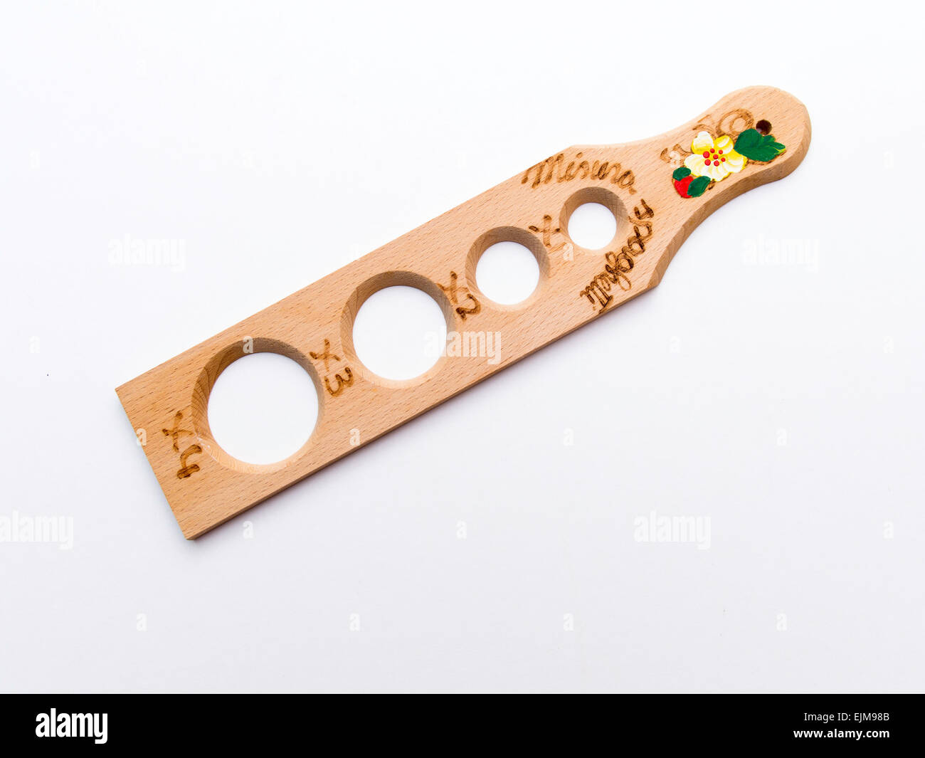 An Italian Spaghetti measure made of beech wood with holes sized to provide portions to suit 1 - 4 persons Stock Photo