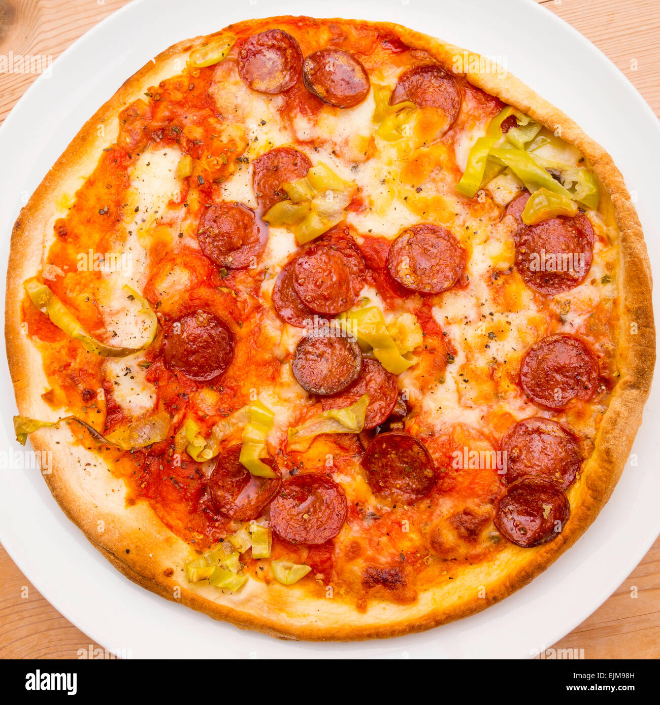 Classic American  Pizza  with Pepperoni and  Hot Peppers on a white plate Stock Photo