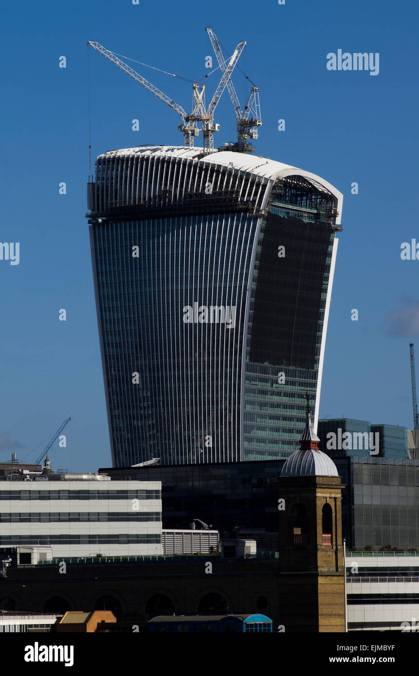 The walkie-talkie building in Central London at 20 Fenchurch Street,under construction with cranes on it Stock Photo