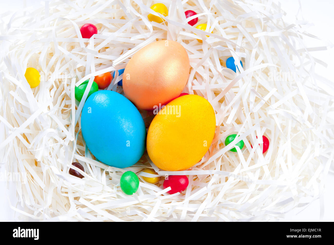 Colorful Easter eggs in nest on white background Stock Photo - Alamy