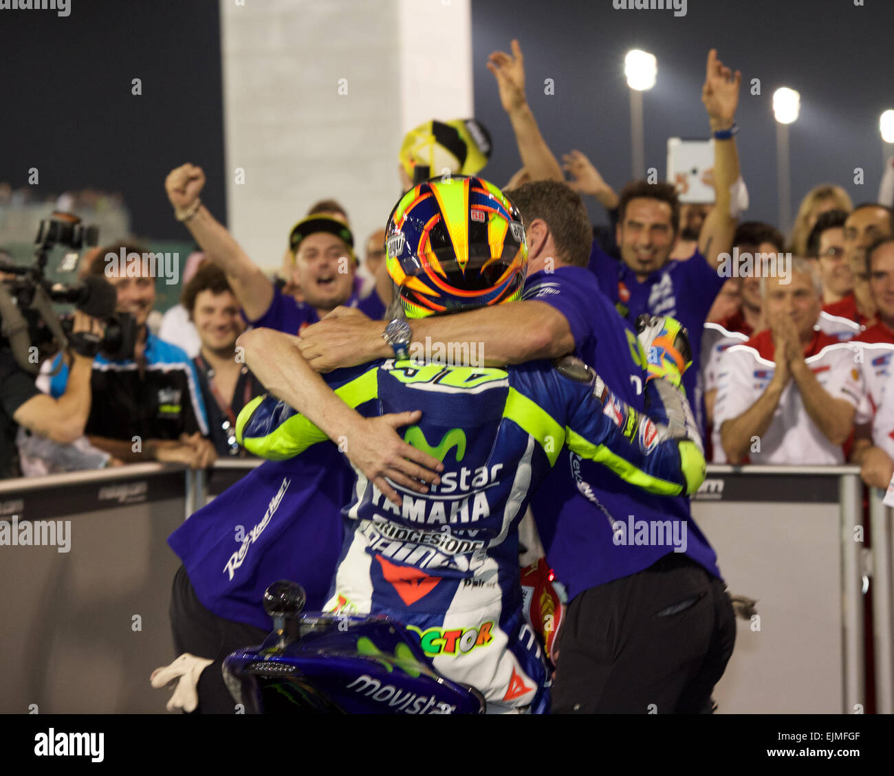 Losail Circuit, Qatar 29th March 2015, Valentino Rossi is congratulated by his team after winning the 2015 FIM Motorcycle Grand Prix of Qatar © Tom Morgan / Alamy Stock Photo