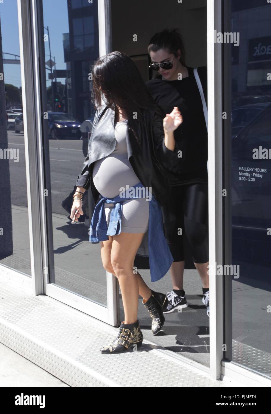 Pregnant Kourtney Kardashian shows off her baby bump while out with her