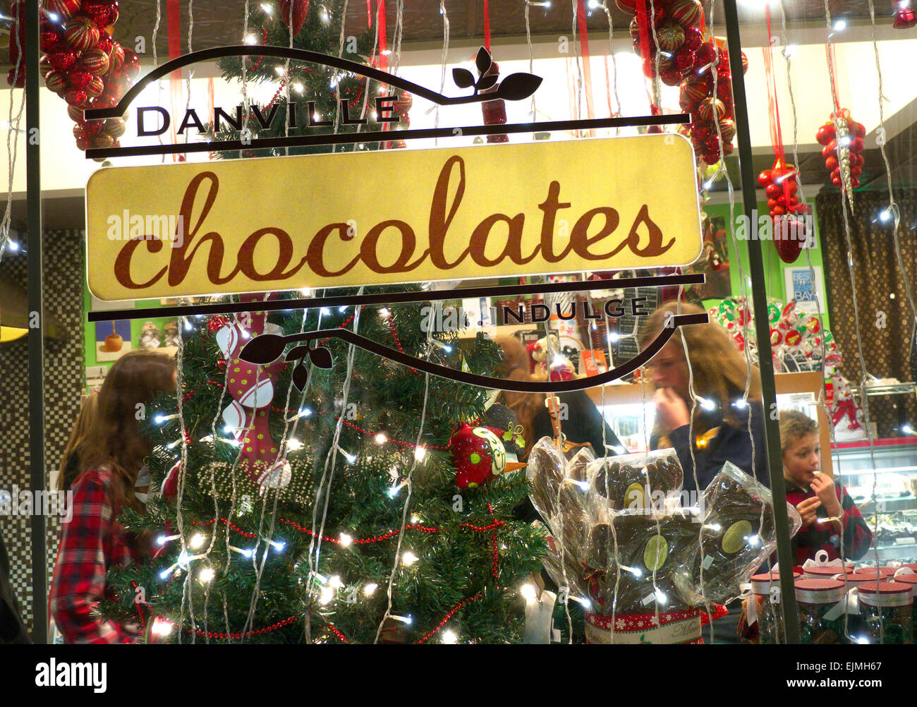 Enticing specialty Chocolate shop at Christmas time with children enjoying free samples Danville California USA Stock Photo