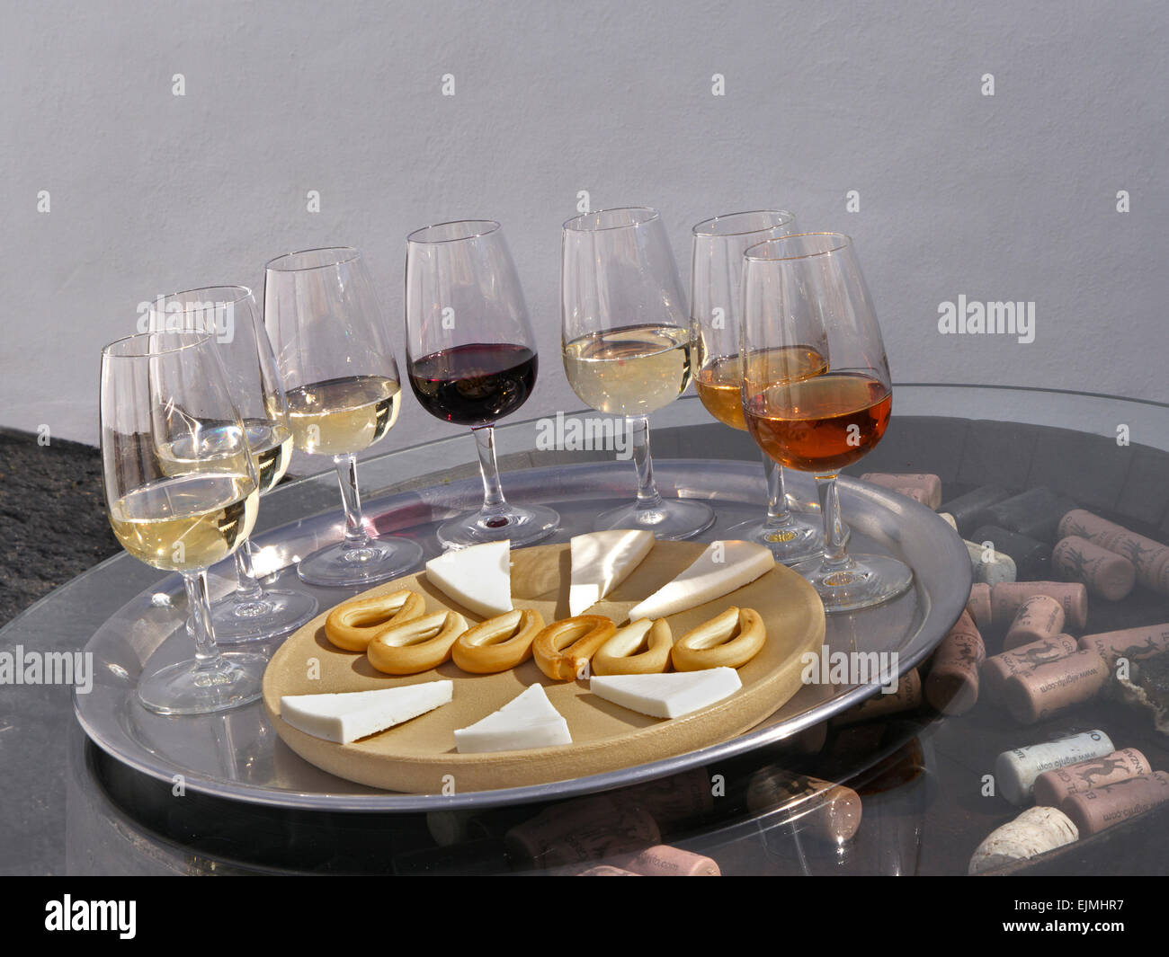 SPANISH WINE tasting glasses alfresco situation red and white wine selection, cheese and dry biscuits on barrel end with corks Canary Islands Spain Stock Photo