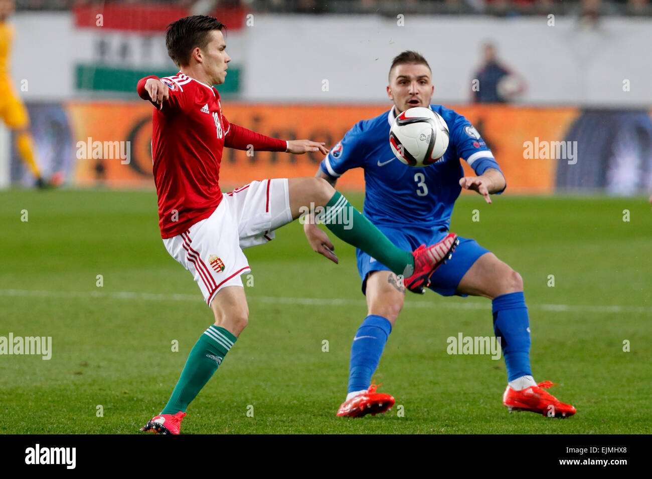 Budapest, Hungary. 29th March, 2015. Hungarian Zoltan Stieber (l) is watched by Greek Kostas Stafylidis during Hungary vs. Greece UEFA Euro 2016 qualifier football match in Groupama Arena. Credit:  Laszlo Szirtesi/Alamy Live News Stock Photo