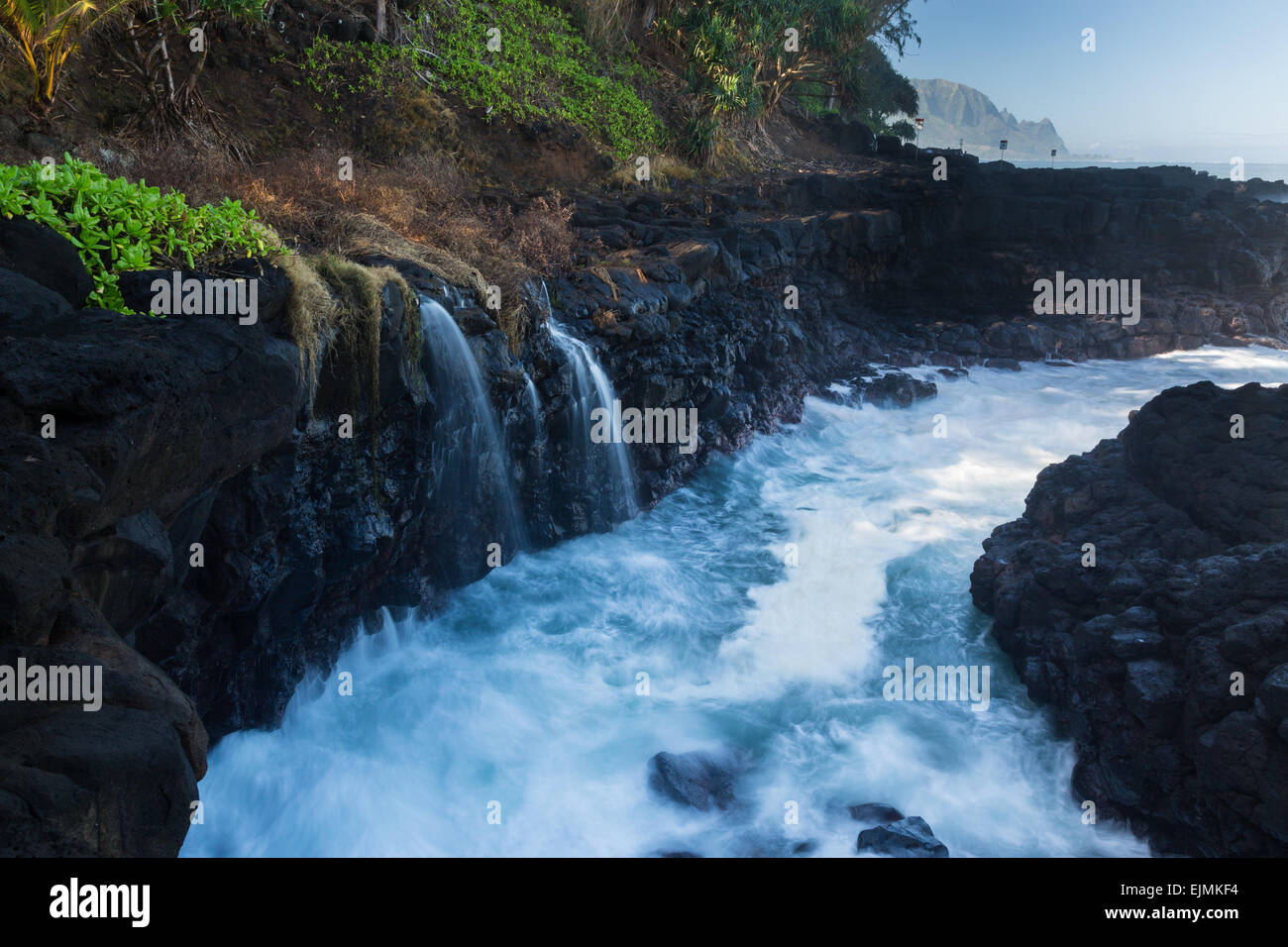 Waves crash into narrow gully by Queens Bath Princeville, Kauai, Hawaii