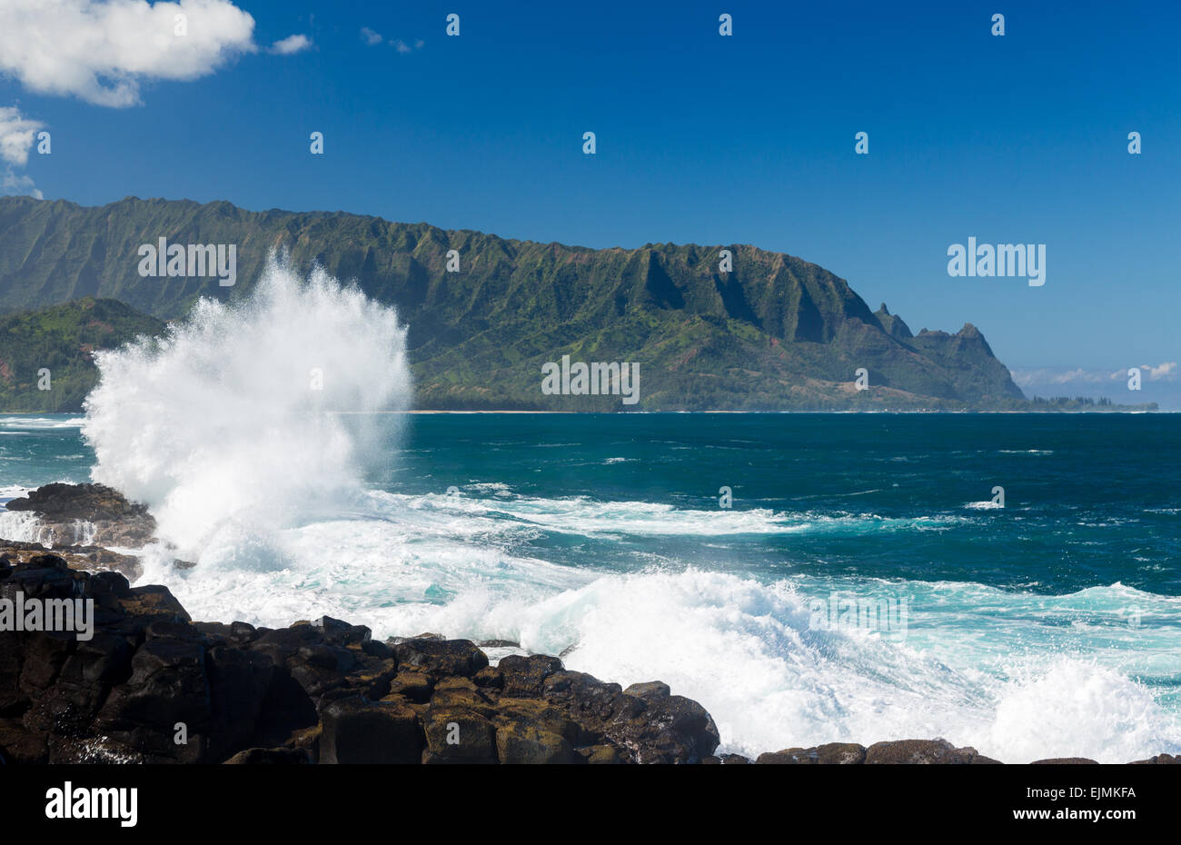 Waves crash into narrow gully that forms Queens Bath at Princeville