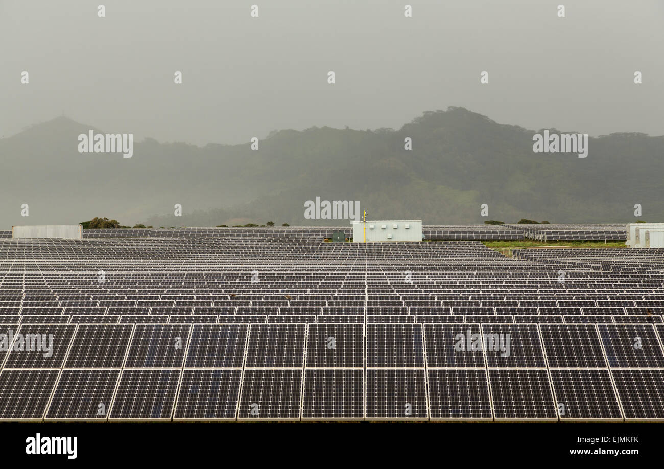 Rows of solar panels in power station array on a misty and cloudy day