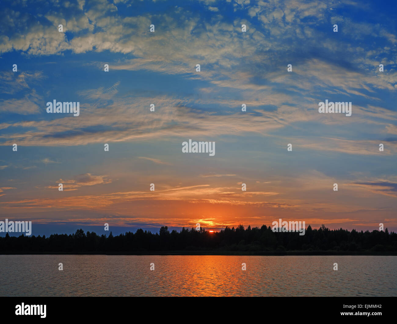 Cloudy sunset over lake Stock Photo - Alamy