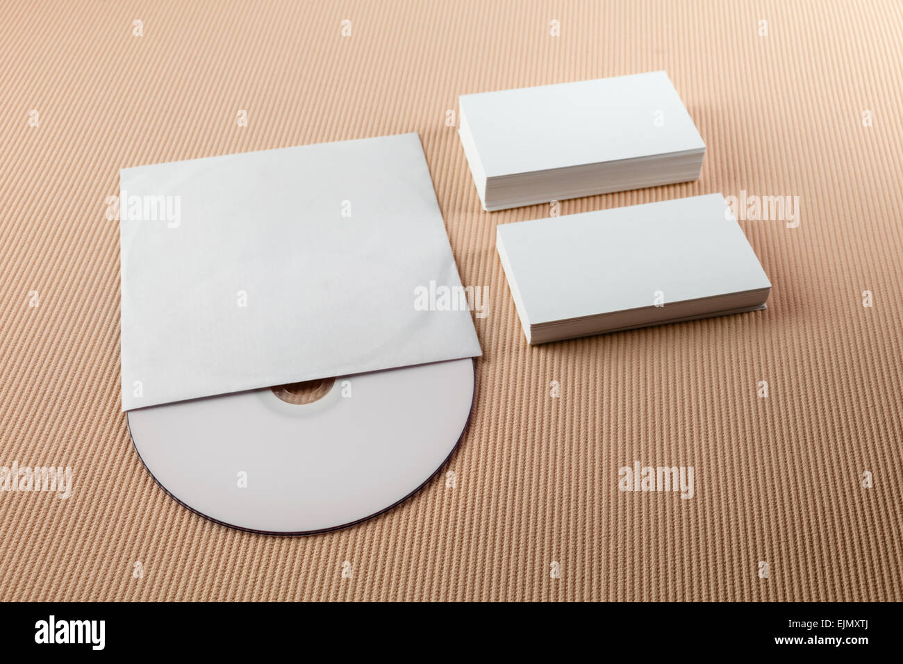 Blank business cards and CD on a beige striped background. Template for branding identity. Stock Photo