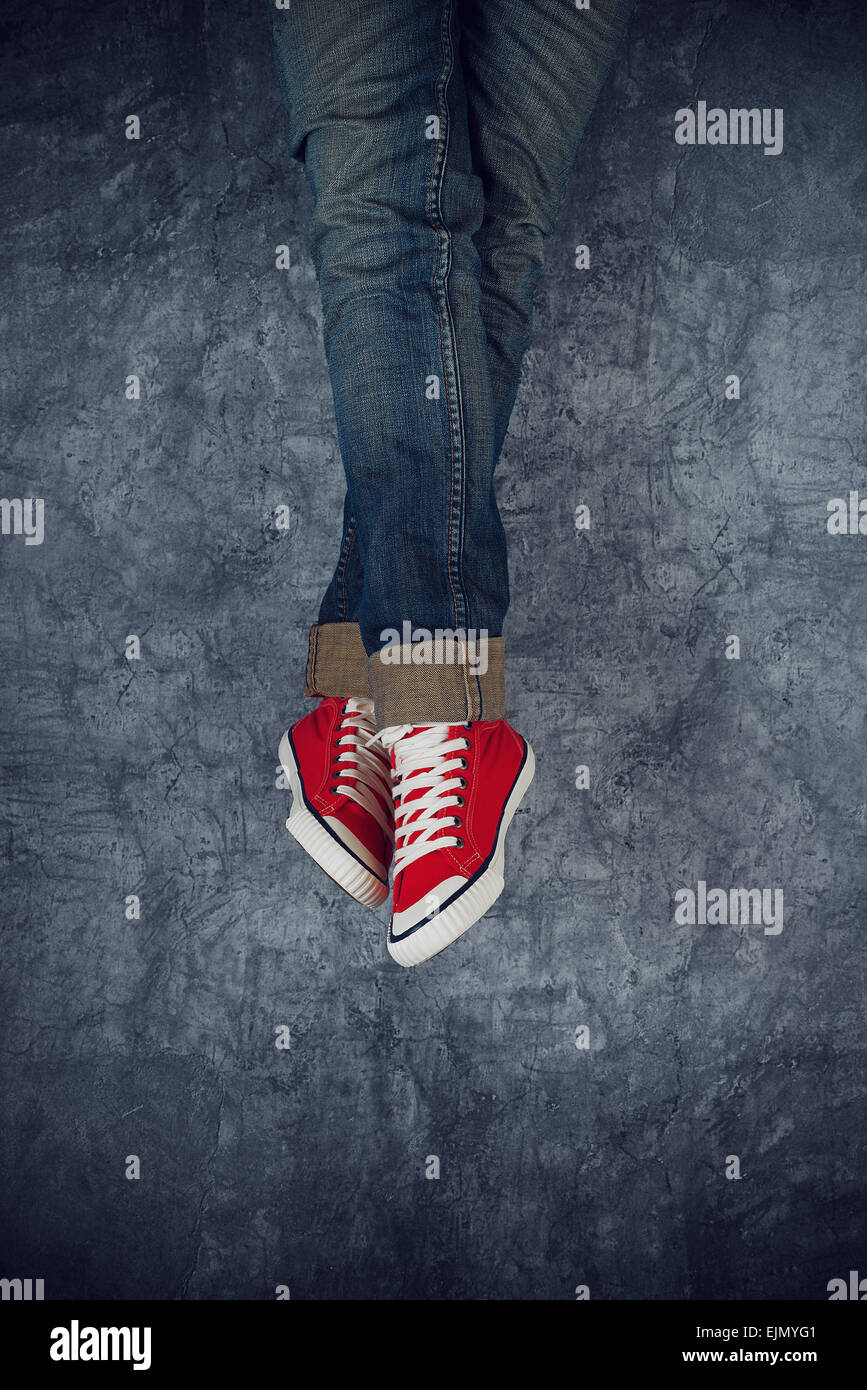 Lazy Young Teenage Woman Relaxing Concept, Red Sneakers on grunge Background Stock Photo