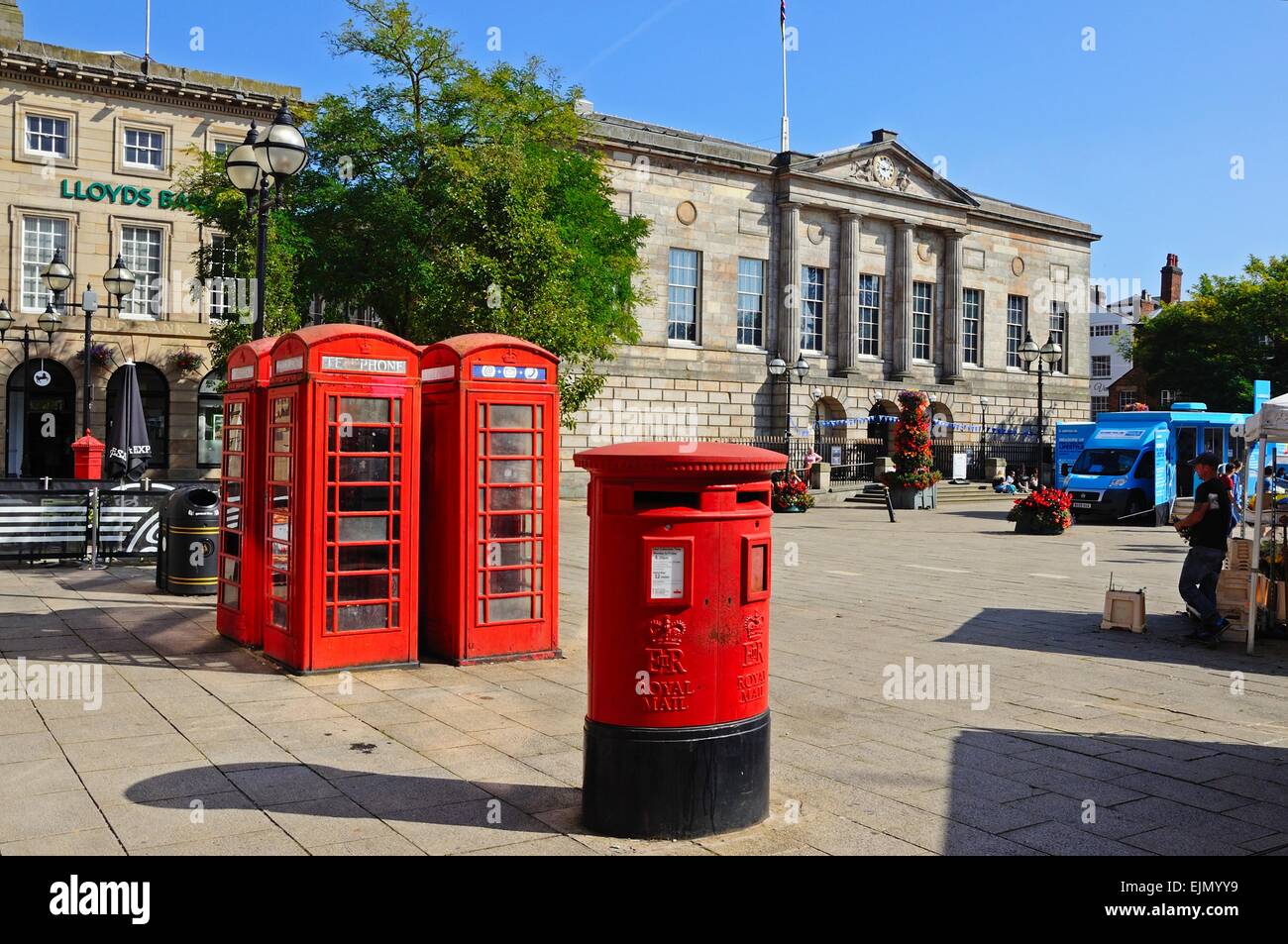 Red post box and telephone boxes with the Shire Hall Gallery to the rear in Market Square, Stafford, Staffordshire, England, UK, Stock Photo