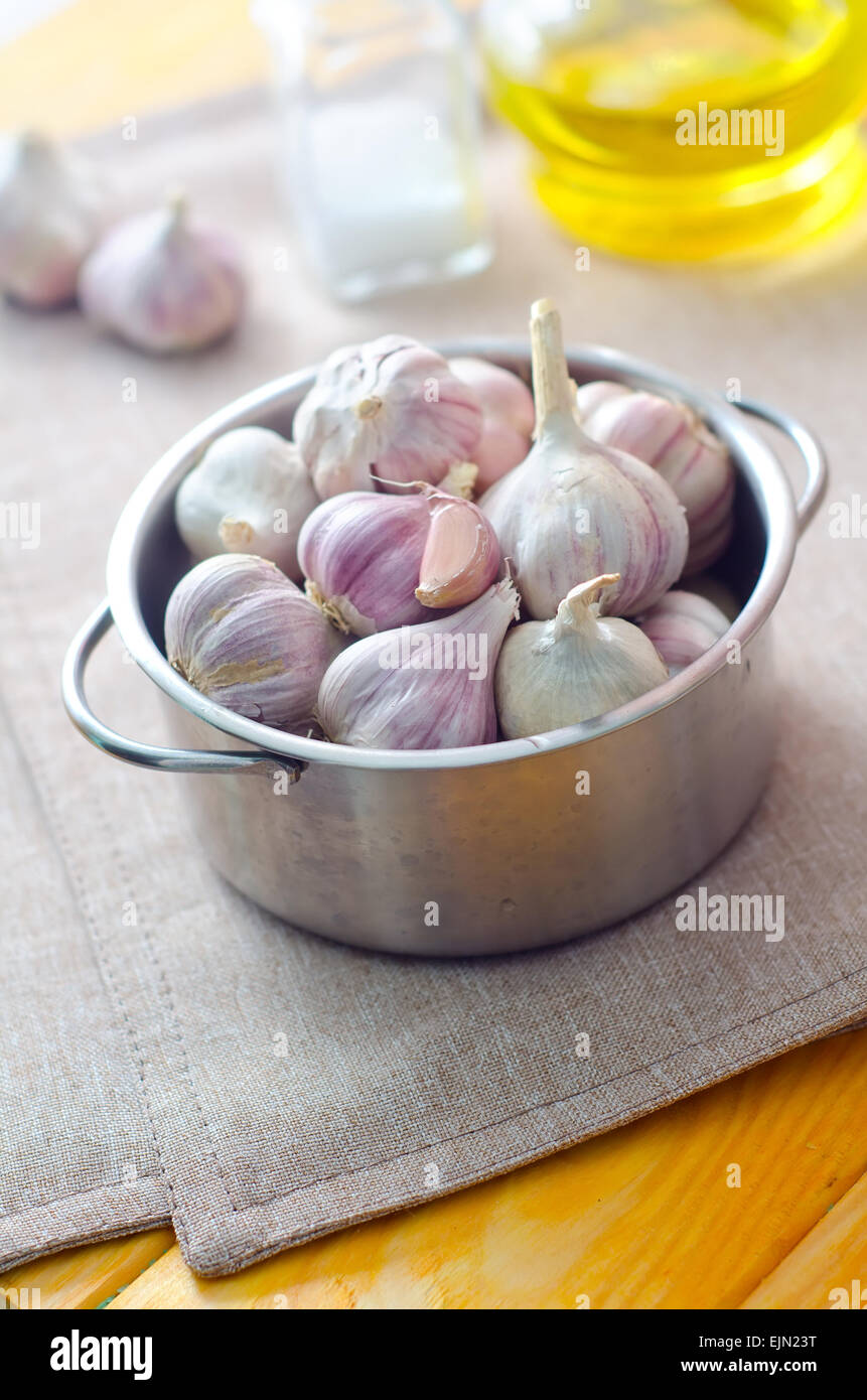 garlic in metal bowl on the table Stock Photo - Alamy