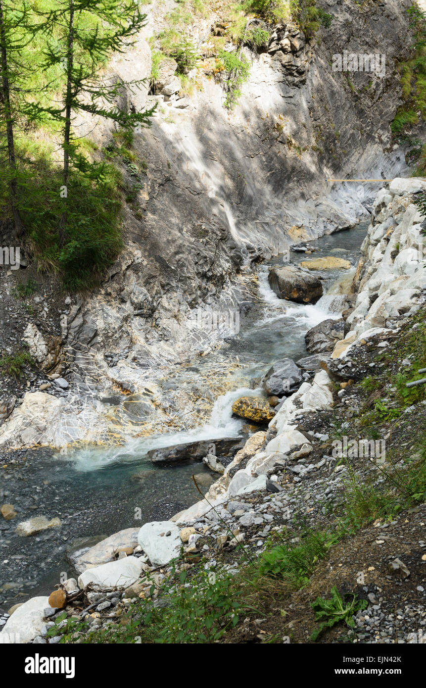 The Thermal Canyon in Leukerbad, Switzerland. The Canyon has a popular walk with thermal springs and large waterfall. Stock Photo