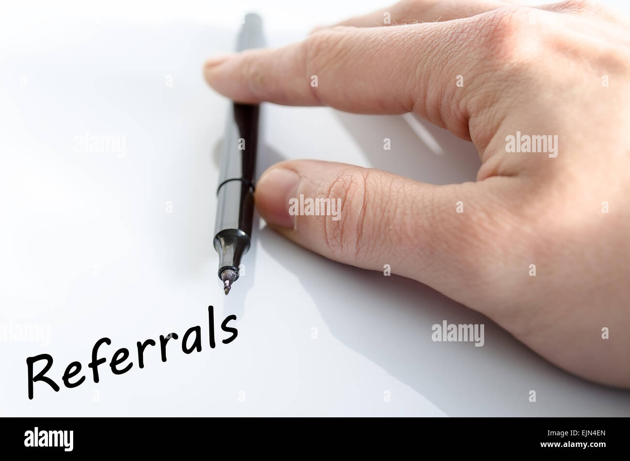 Human hand writing Referrals isolated over white background - business concept Stock Photo