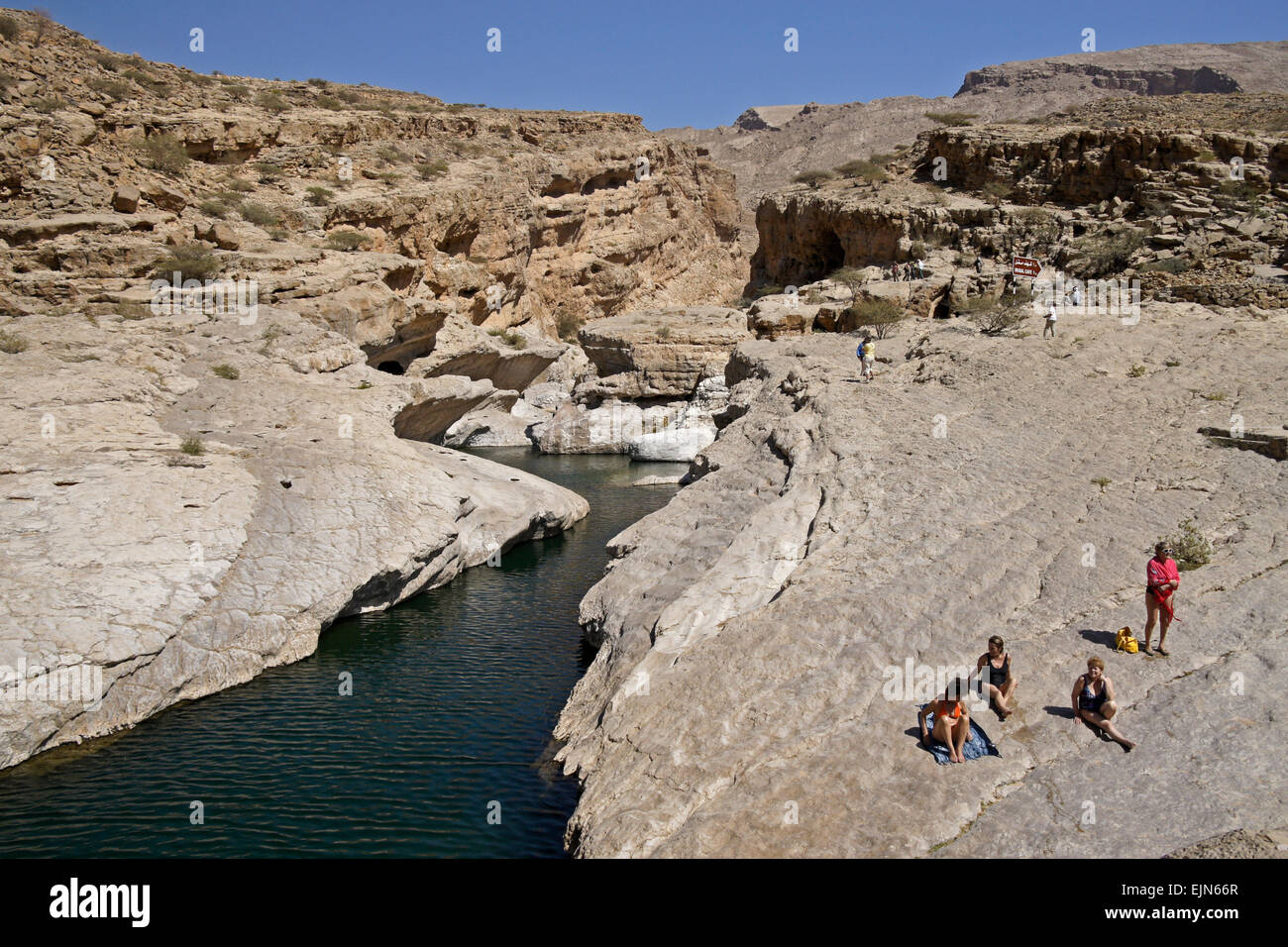 Tourists enjoying the sun and water in Wadi Bani Khalid, Sultanate of Oman Stock Photo