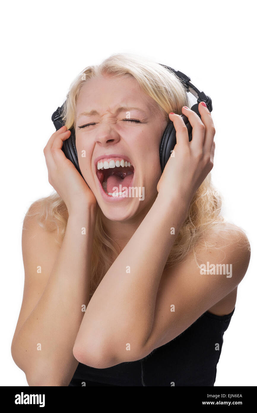 A young natural blond girl wearing headphones while screaming Stock Photo