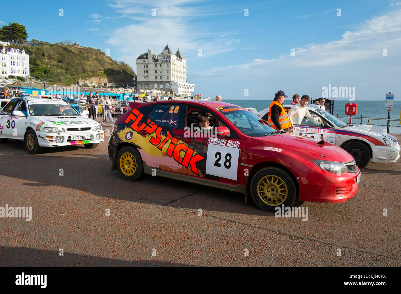 Rally cars on the seafront at Llandudno, Wales, at the start of the Cambrian Rally. Stock Photo