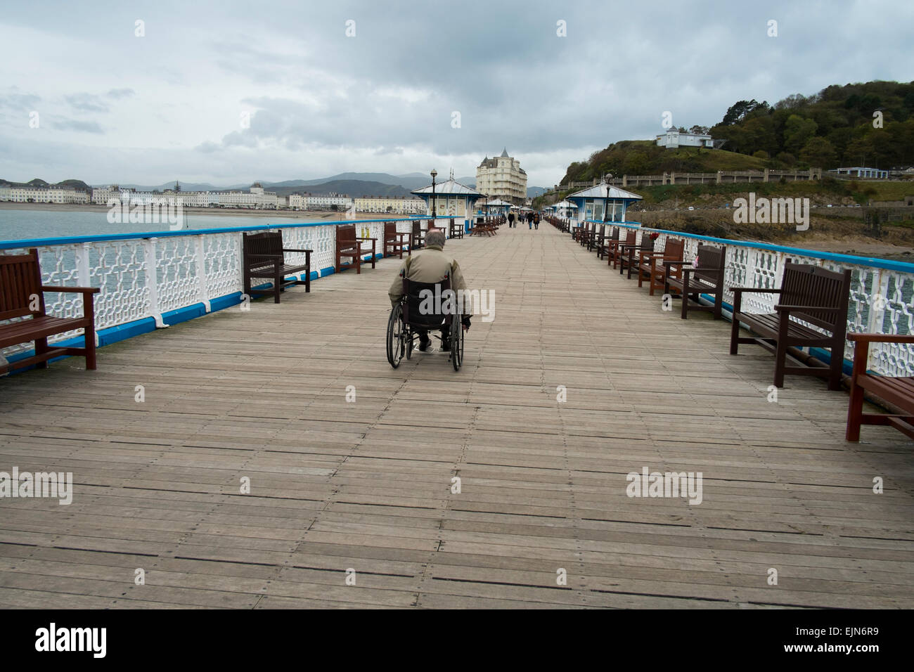 Disabled man in wheelchair on Llandudno pier, Conwy, Wales, UK Stock Photo
