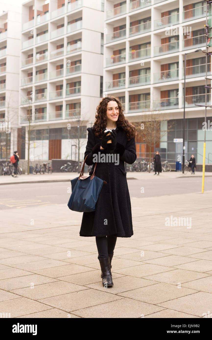  Woman walking in the street holding fashion handbag