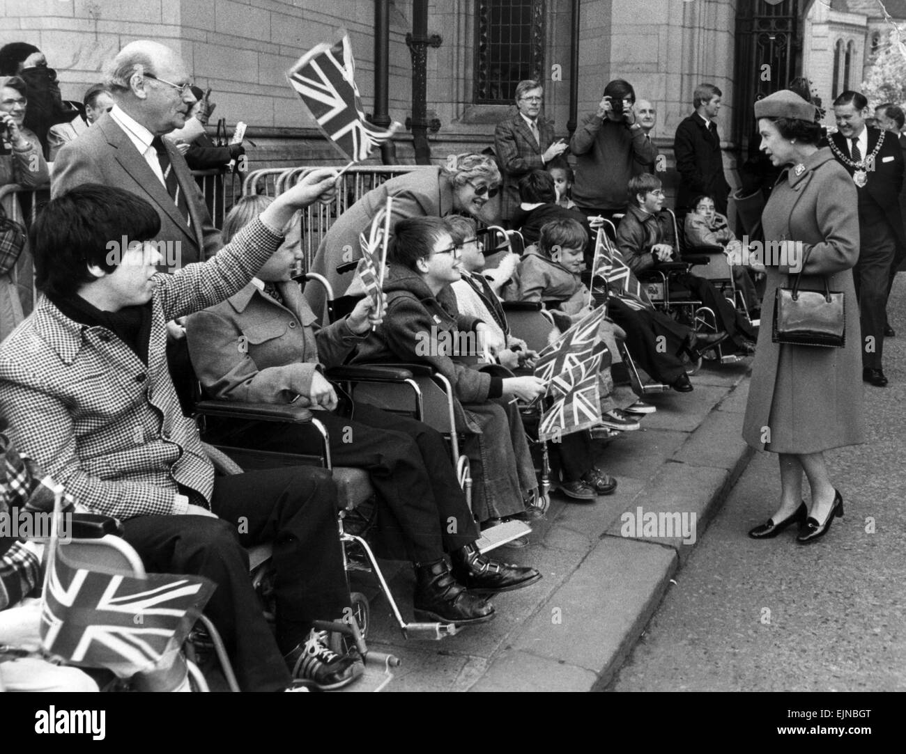 The Queen visits Manchester, 5th May 1982. Disabled youngsters provide a patriotic greeting outside Manchester University. Stock Photo
