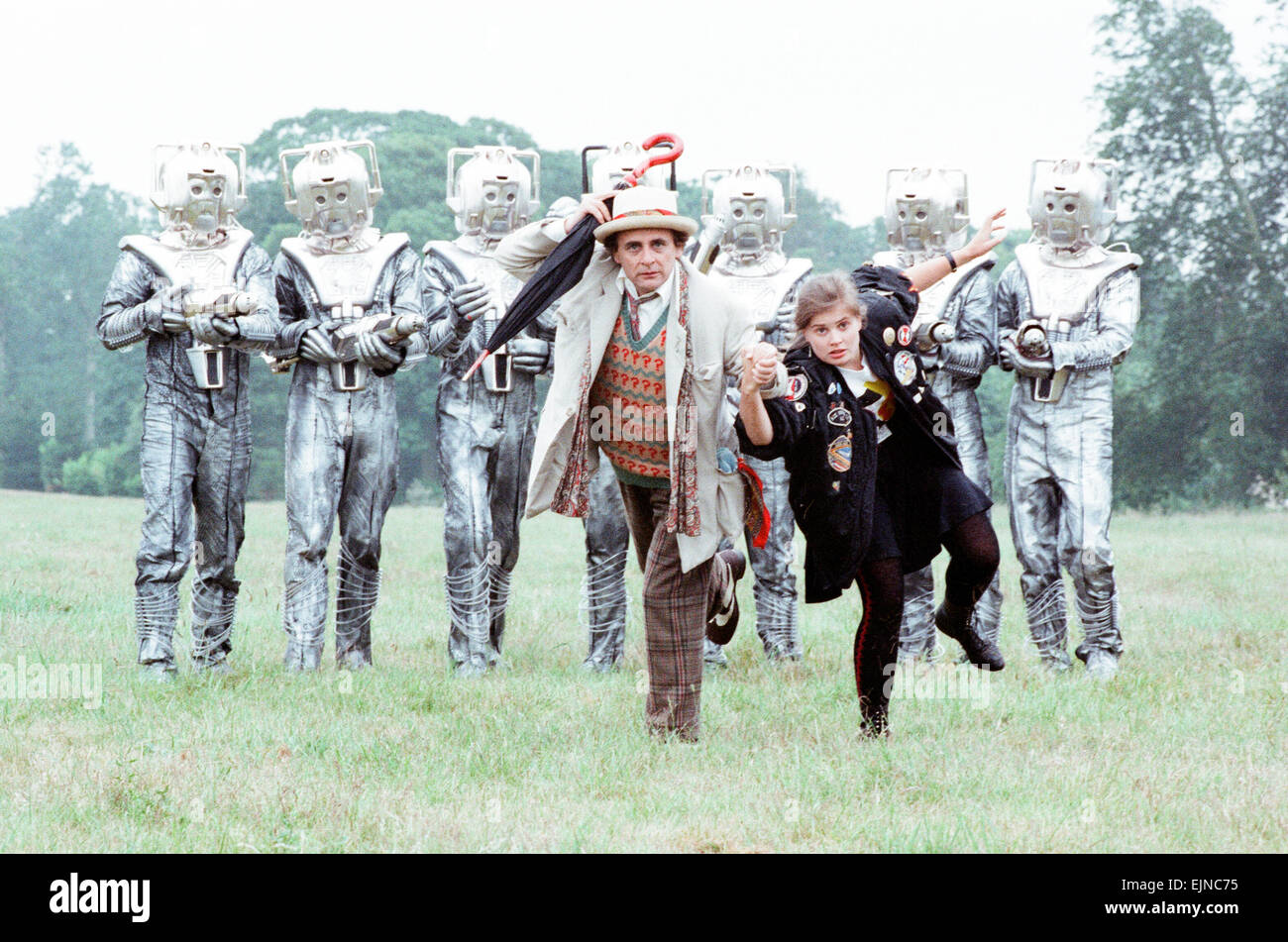 Sylvester McCoy as the Doctor and Sophie Aldred as Ace seen here on location near Arundel with the Cybermen during the filming of the Dr Who story called The Silver Nemesis. 28th June 1988 Stock Photo