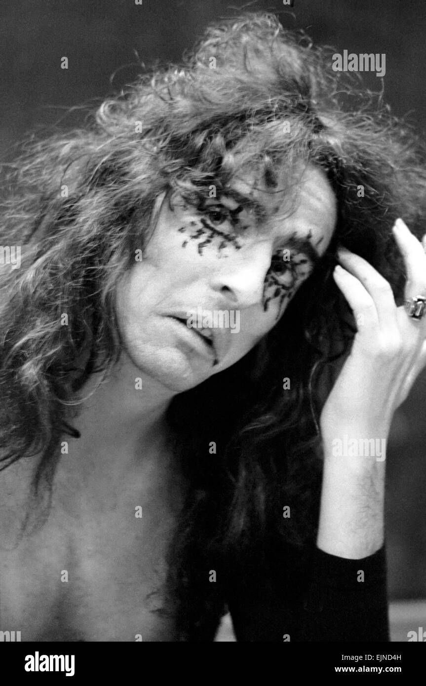 Pop singer Alice Cooper aged 23 flew into Heathrow Airport today with his pet boa constrictor, wearing a flimsy see-through shirt with no buttons. He calls his python Rachina and allowed it to slide over his face and neck. Alice Cooper flew in from the United States and will be appearing in Britain. He is staying in London. 21st October 1971. Stock Photo