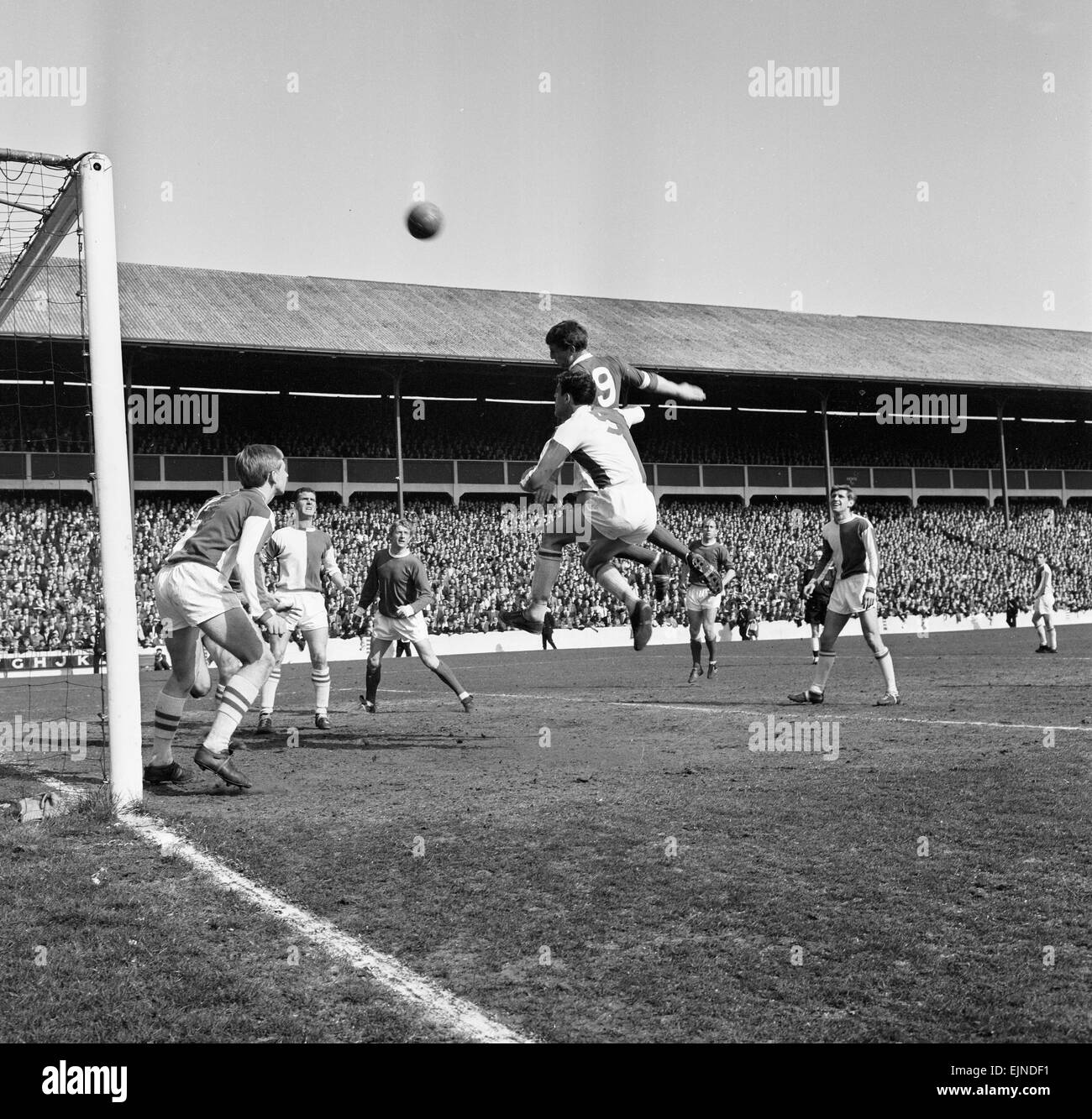 Blackburn Rovers v Manchester United, league match at Ewood Park, Saturday 3rd April 1965. Herd tries a header, closely tackled by England, ball goes over bar. Wilson on goal line. Clayton and Denis Law watch. Final Score: Blackburn Rovers 0-5 Manchester United Stock Photo
