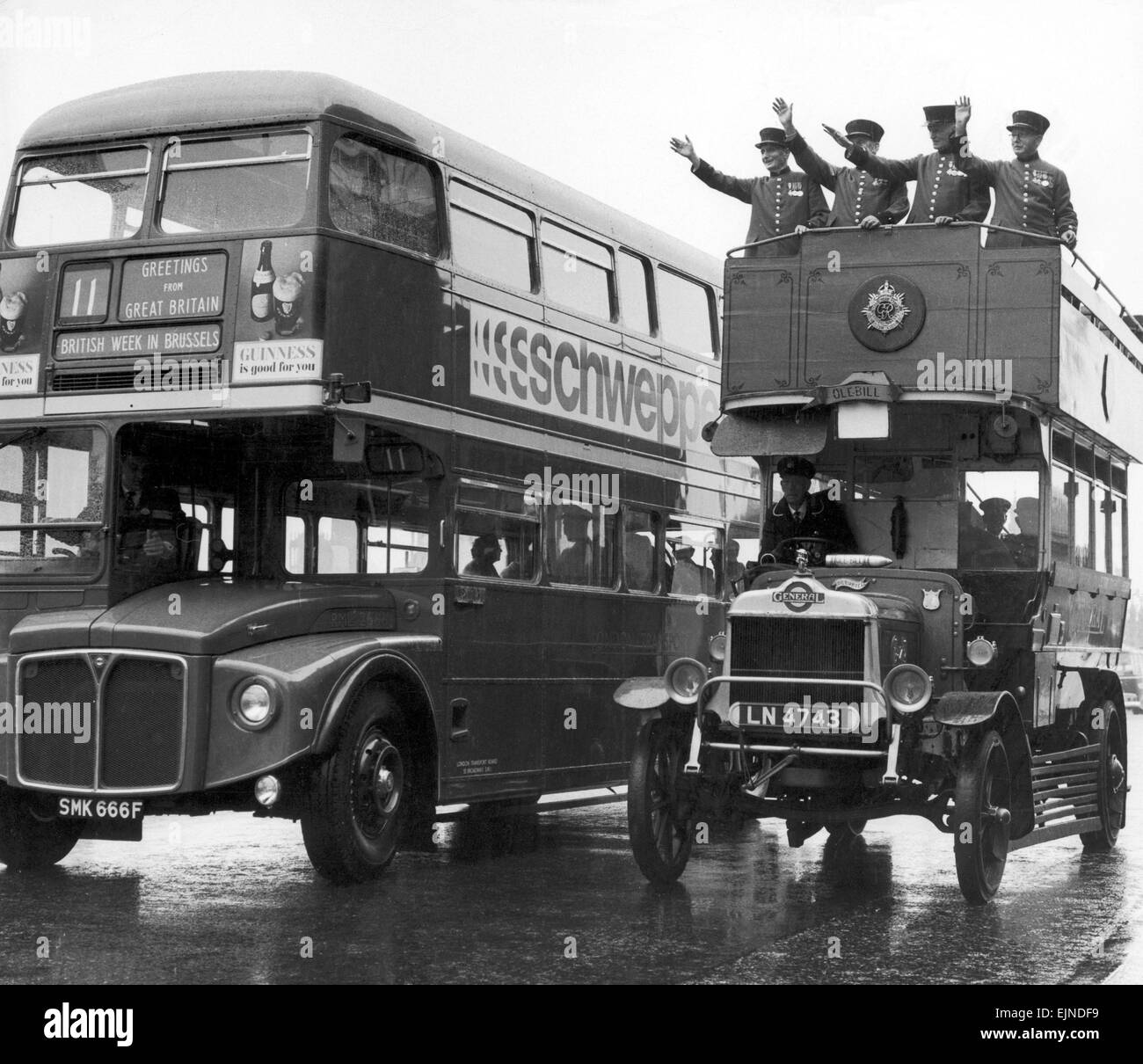 Ole Bill ,a London bus from around 1914, is overtaken by one of the modern day Routemaster buses on Waterloo Bridge. On top are four Chelsea pensioners waving off the Routemaster as it leaves Tilbury for Brussels for 'British Week'. 25th September 1967. Stock Photo