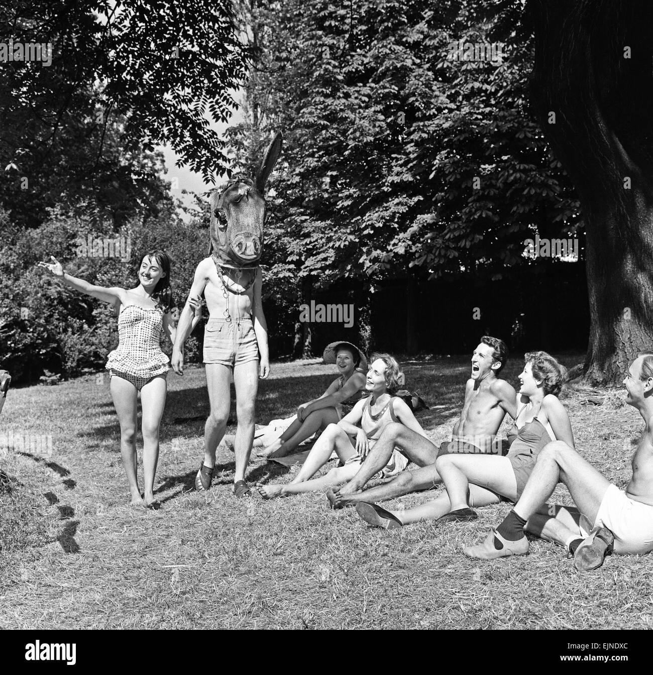 Rehearsal for the new Open Air Theatre production of Willam Shakespeare's ' A Midsummer Night's Dream' at Regents Park, London with cast members dressed in bathing costumes. Picture shows: 'Titania' played by Mary Duddy, taking a stroll with Pete John who stood in for 'Bottom' to be played by producer and director Robert Atkins. 8th July 1959. Stock Photo