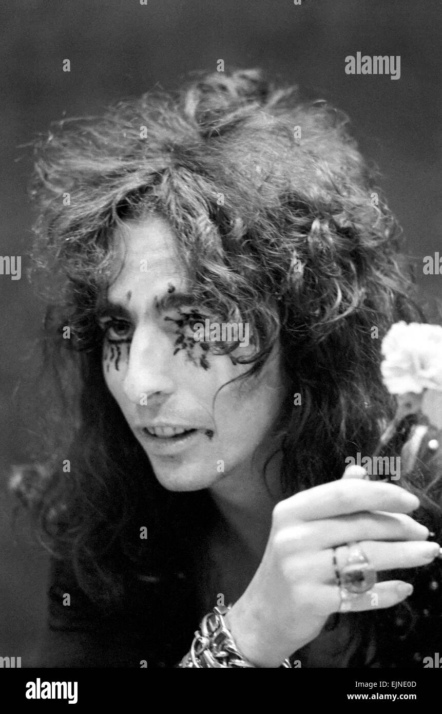Pop singer Alice Cooper aged 23 flew into Heathrow Airport today with his pet boa constrictor, wearing a flimsy see-through shirt with no buttons. He calls his python Rachina and allowed it to slide over his face and neck. Alice Cooper flew in from the United States and will be appearing in Britain. He is staying in London. 21st October 1971. Stock Photo