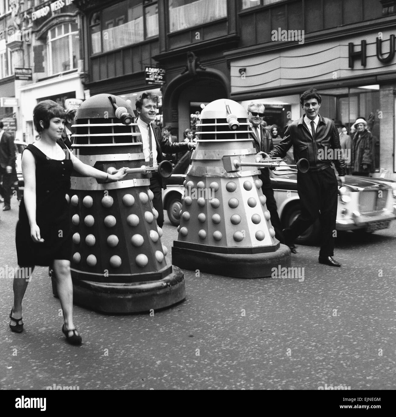 The Daleks come to Bond Street, London. A new pop group calling themselves the ' Go Goes' seen here in London's West End shortly before recording their new song, ' I'm Gonna have a Dalek for Christmas' The group pose with two of the alien robots from the TV show Dr Who. 25th November 1964 Stock Photo