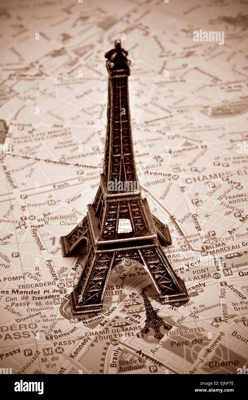 a reproduction of the Eiffel Tower on a map of Paris, with sepia toning Stock Photo