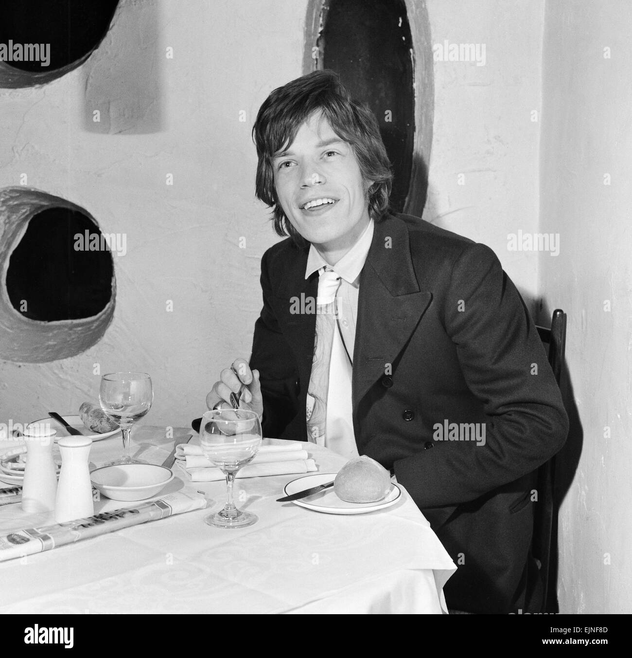 Rolling Stones singer Mick Jagger having dinner at Italian restaurant Trattoria Terrazza in Soho. 23rd December 1966 Stock Photo