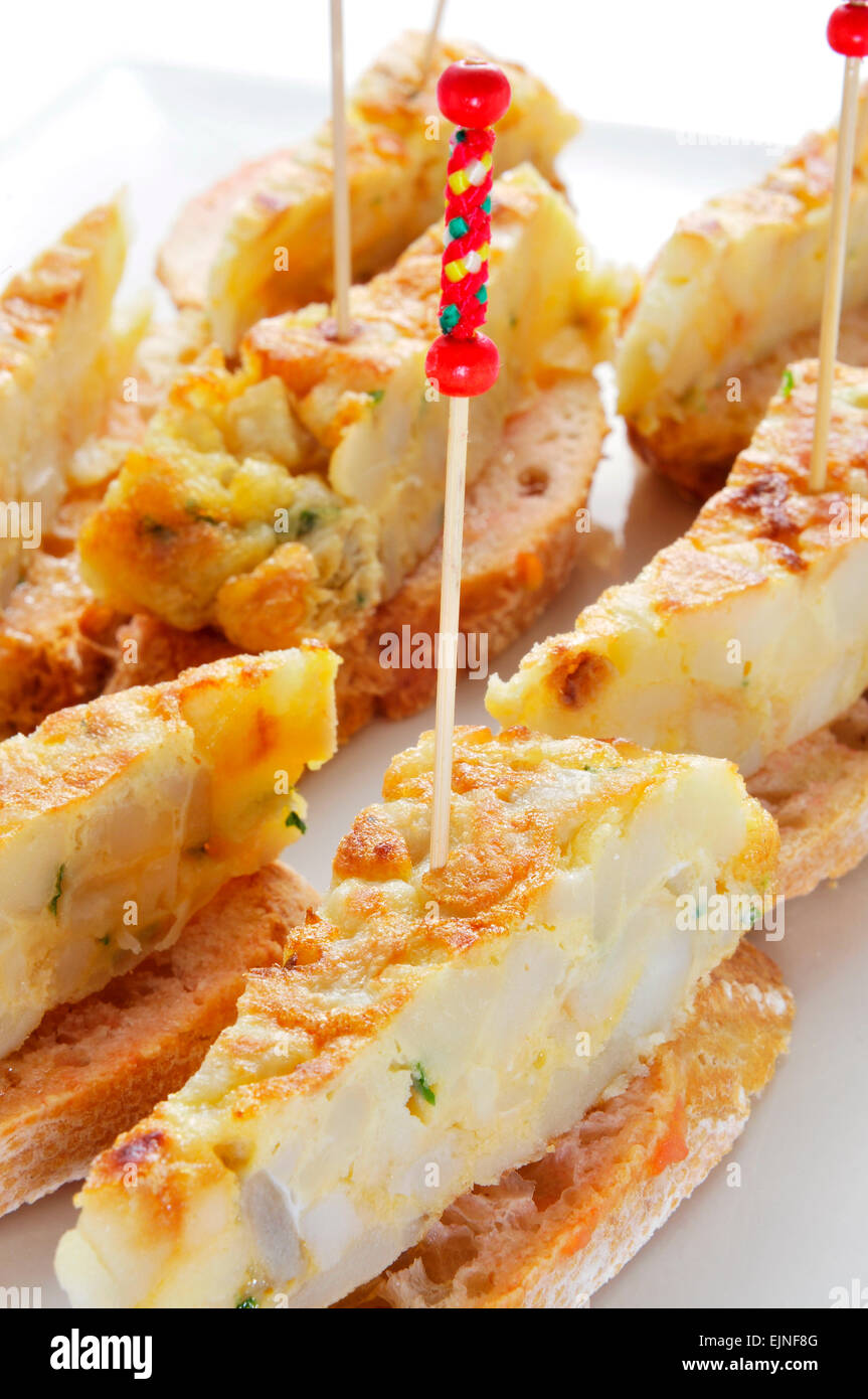 closeup of a plate with typical spanish pincho de tortilla, spanish omelete served on bread Stock Photo