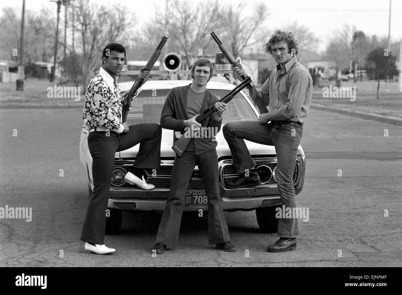 Muhammad Ali and Joe Bugner in America: 'The Liquidators' - the three English boxers who meet the Americans pictured at Henderson County Police Station with a squad car and holding shot guns. L/R John Conteh, John H. Stacey and Joe Bugner. February 1973 Stock Photo