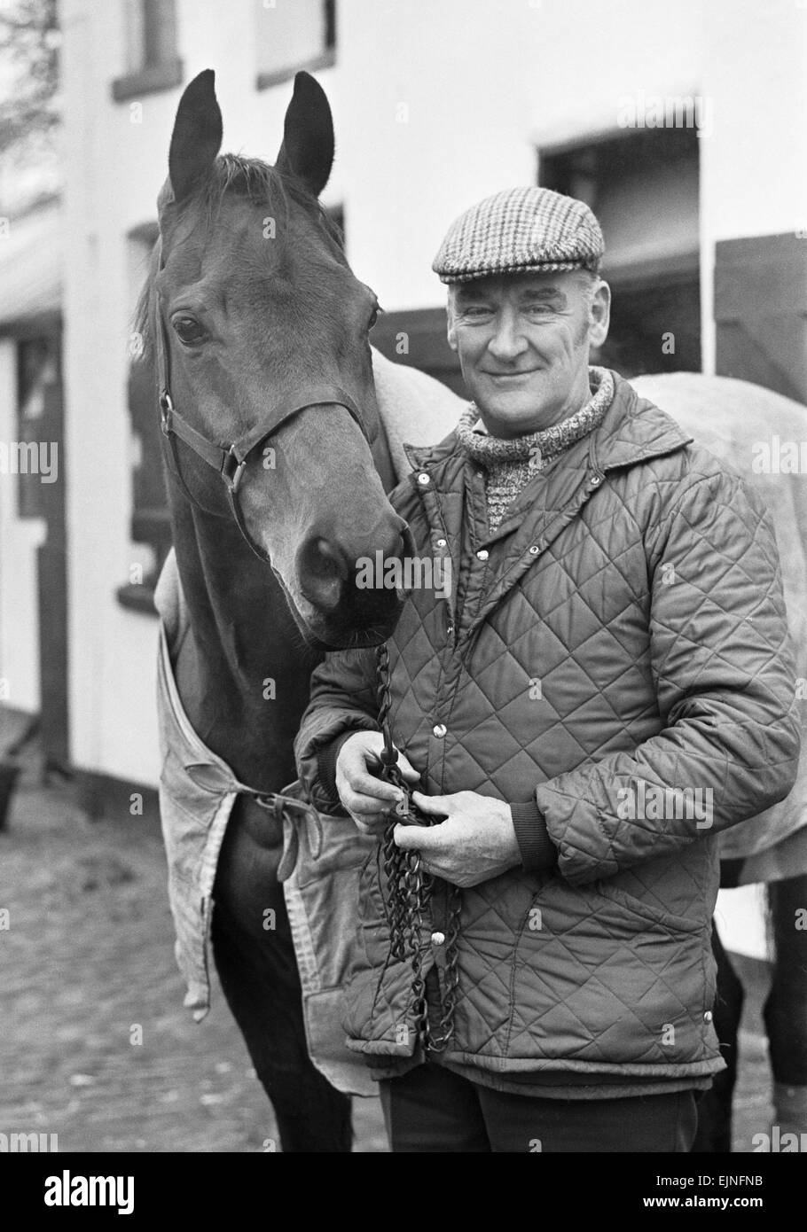 Donald 'Ginger' McCain, the trainer of three times Grand National winner Red Rum, pictured with the famous racehorse at their stables in Birkdale, Southport in Merseyside. 13th January 1978. Stock Photo