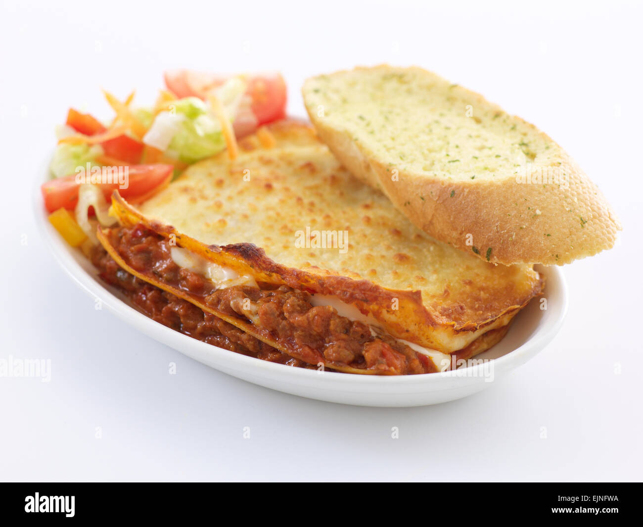 Beef Lasagne with salad and garlic bread Stock Photo Alamy