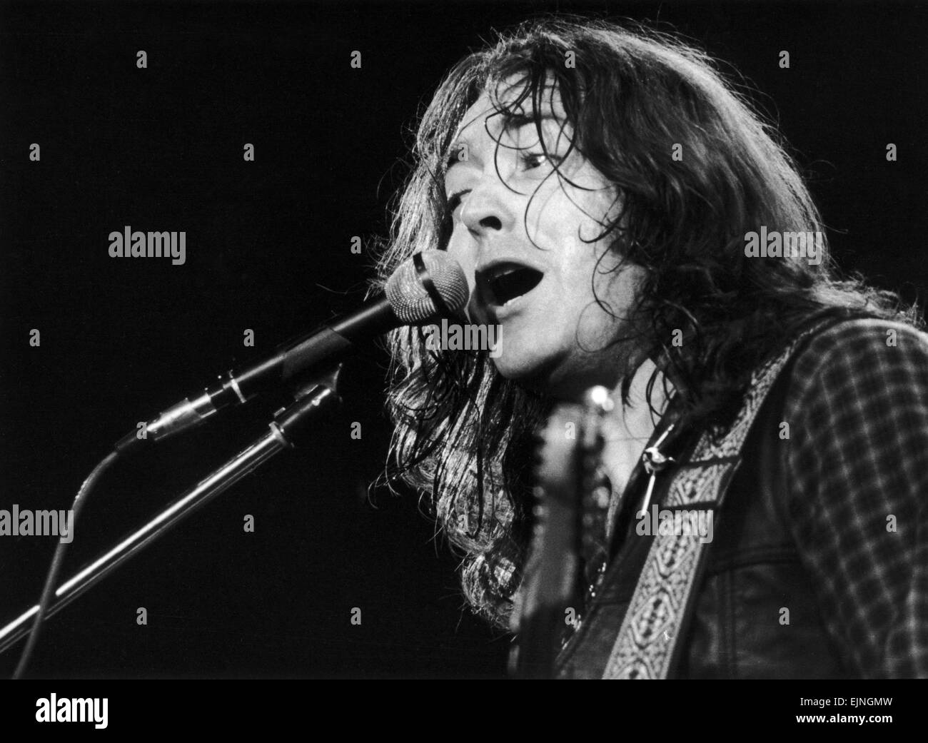Irish blues rock musician and singer Rory Gallagher piuctured performing in concert during his tour of Europe. April 1982. Stock Photo