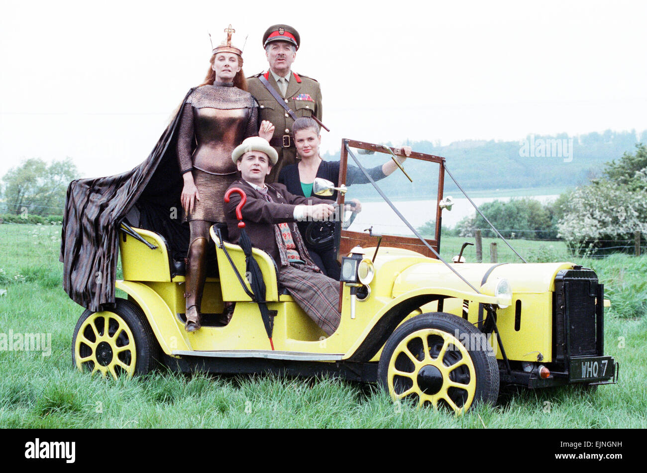 Sylvester McCoy as the Doctor, Jean Marsh as Morgaine, Nicholas Courtney as Brigadier Lethbridge Stewart and Sophie Aldred as Ace pose with the Doctor's car Bessie whilst on location filming for the Dr Who story Battlefield. 16th May 1989 Stock Photo