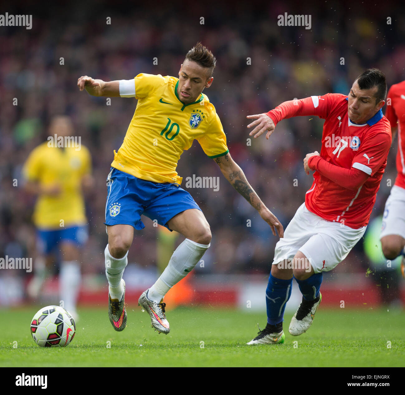 London, UK. 29th Mar, 2015. International Football Friendly. Brazil versus Chile. Brazil's Neymar gets away from Chile's Gary Medel. Credit:  Action Plus Sports/Alamy Live News Stock Photo