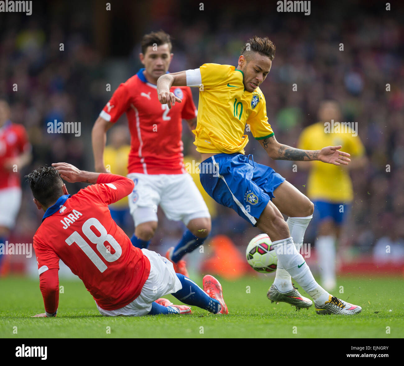 London, UK. 29th Mar, 2015. International Football Friendly. Brazil versus Chile. Brazil's Neymar jumps to avoid the challenge from Chile's Gonzalo Jara. Credit:  Action Plus Sports/Alamy Live News Stock Photo