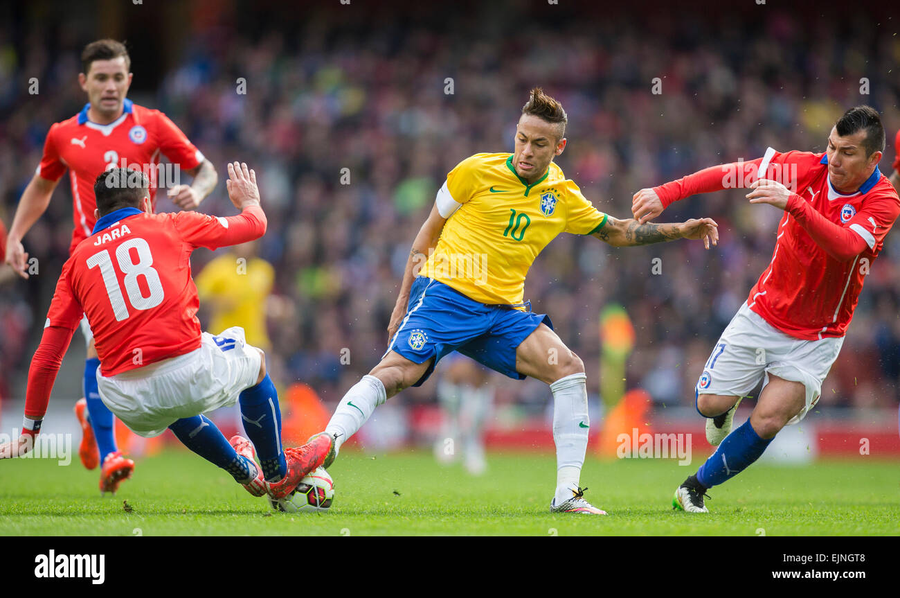 London, UK. 29th Mar, 2015. International Football Friendly. Brazil versus Chile. Chile's Gonzalo Jara (left) puts the tackle in on Brazil's Neymar as Medel supports. Credit:  Action Plus Sports/Alamy Live News Stock Photo