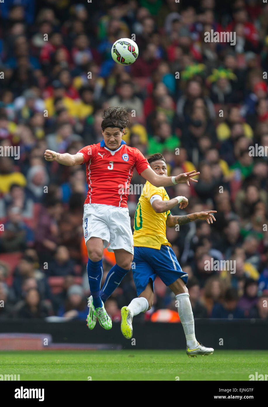 London, UK. 29th Mar, 2015. International Football Friendly. Brazil versus Chile. Chile's Miiko Albornoz heads clear under pressure from Neymar Credit:  Action Plus Sports/Alamy Live News Stock Photo