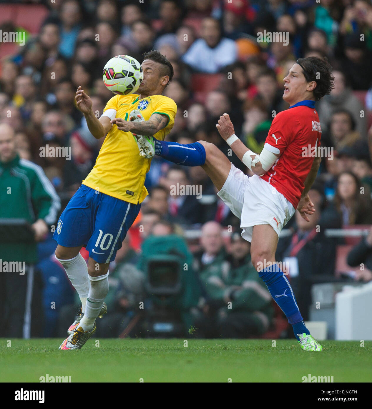 London, UK. 29th Mar, 2015. International Football Friendly. Brazil versus Chile. Brazil's Neymar looks to control the ball on his chest as a high challenge comes in from Chile's Miiko Albornoz. Credit:  Action Plus Sports/Alamy Live News Stock Photo