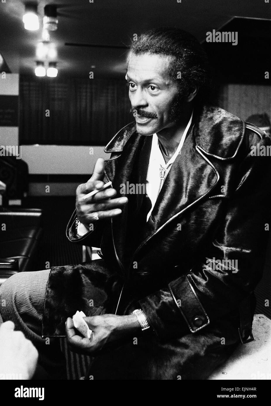 American rock n roll singer Chuck Berry smoking a cigarette after a concert. 22nd February 1975. Stock Photo