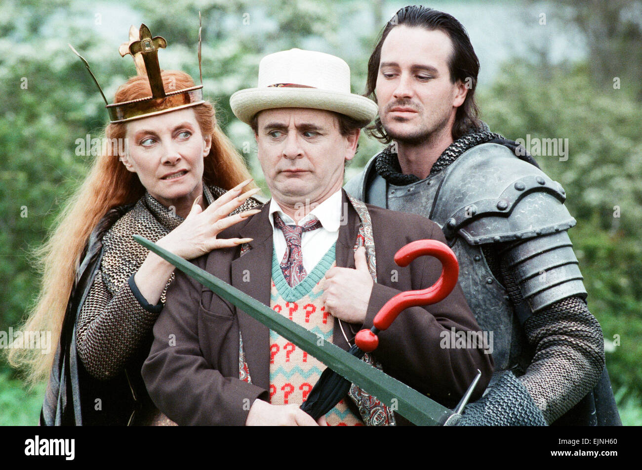 Christopher Bowen as Mordred crosses swords with Sylvester McCoy as the Doctor along with Jean Marsh as Morgaine whilst on location filming for the Dr Who story Battlefield. 16th May 1989 Stock Photo